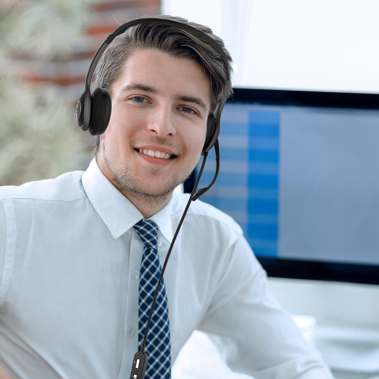 Picture of a Businessman in an office wearing his Connect USB Stereo Headset with Boom Microphone and speaking to a customer.