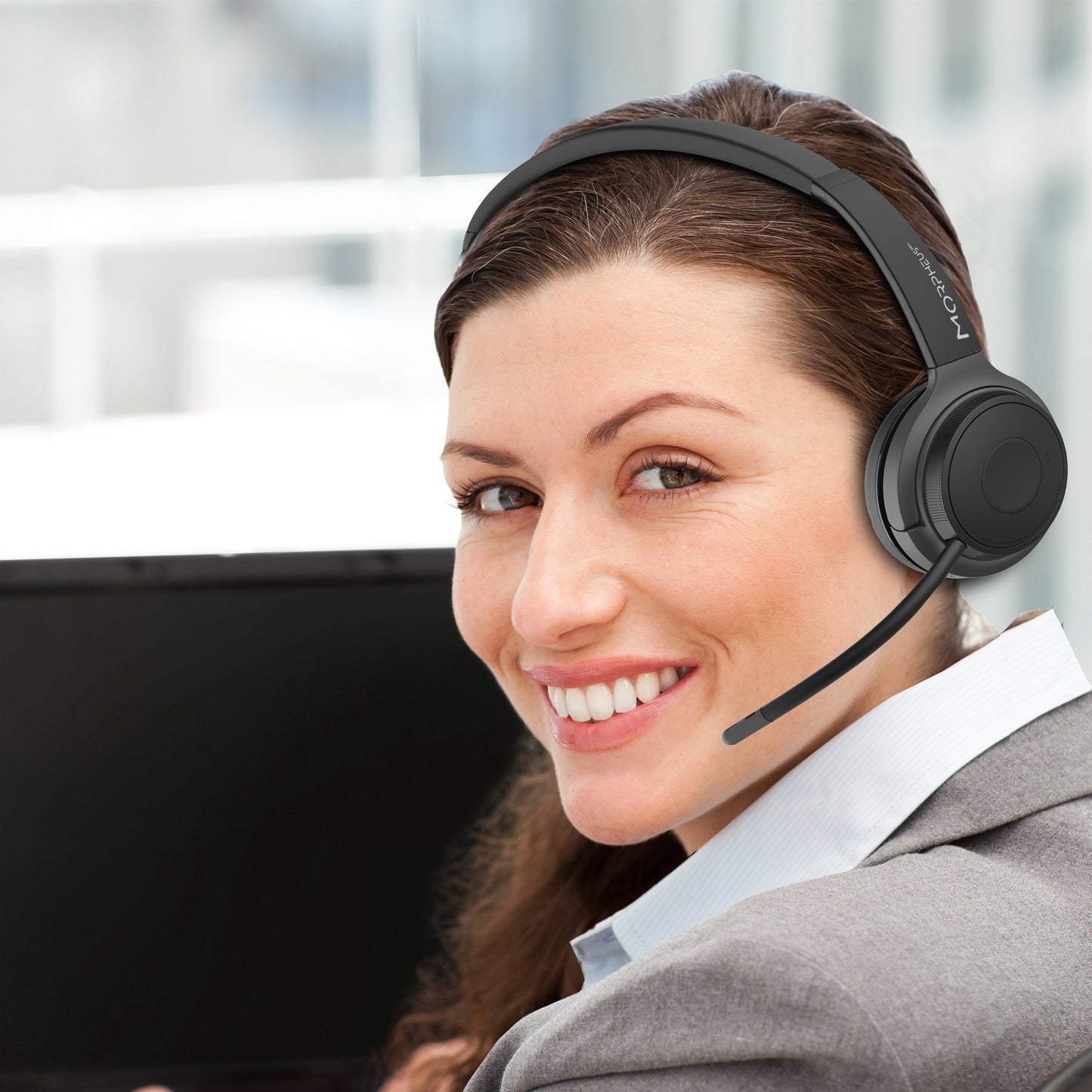 Businesswoman in an office wearing her Advantage Wireless Mono Headset with Boom Microphone and speaking to a customer.