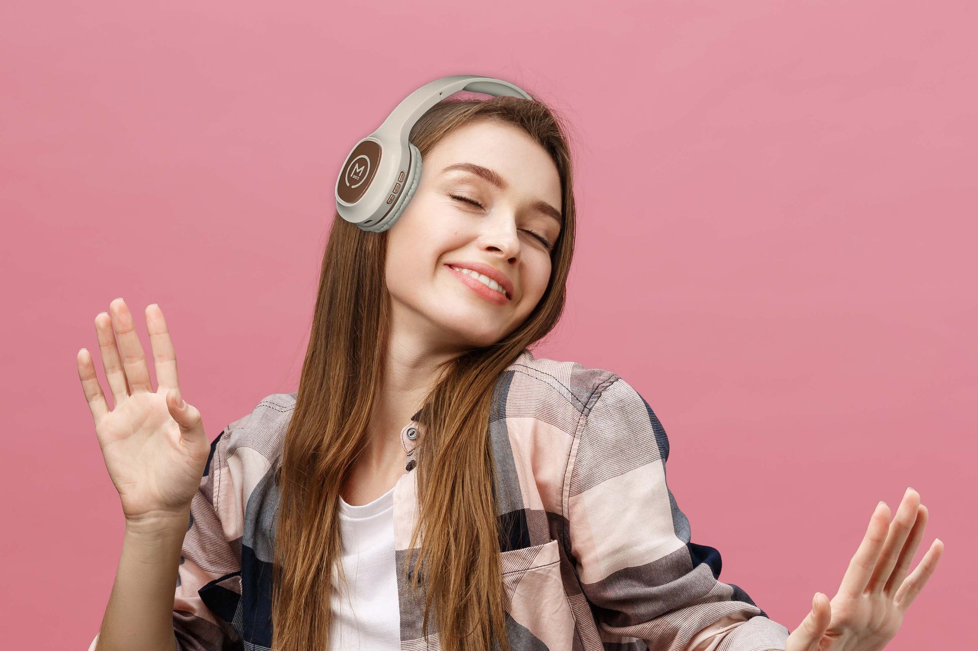 Photo of Morpheus 360 Tremors Wireless on-ear Headphones shows a young white female enjoying the great quality of sound while listening to music.