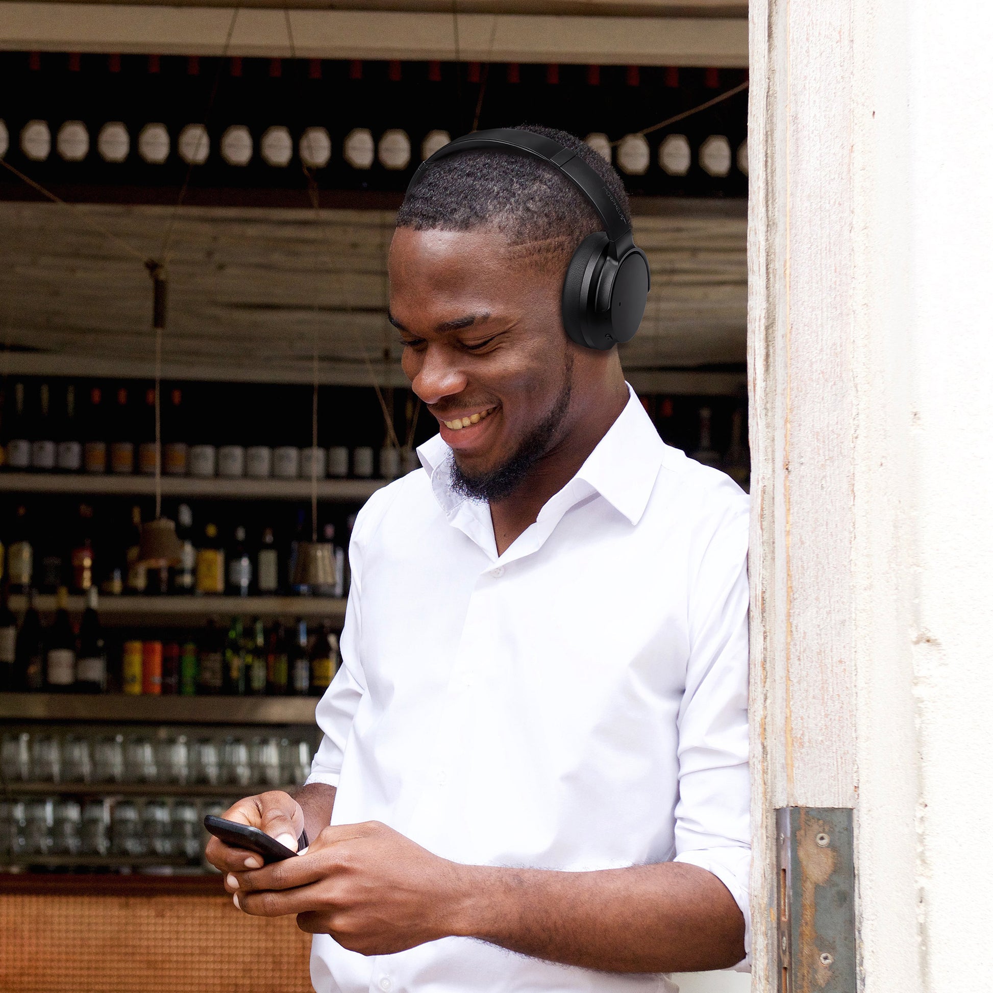 Photo of Morpheus 360 Eclipse 360 shows a Young African American man wearing Eclipse 360 headphones for a business or personal phone call.