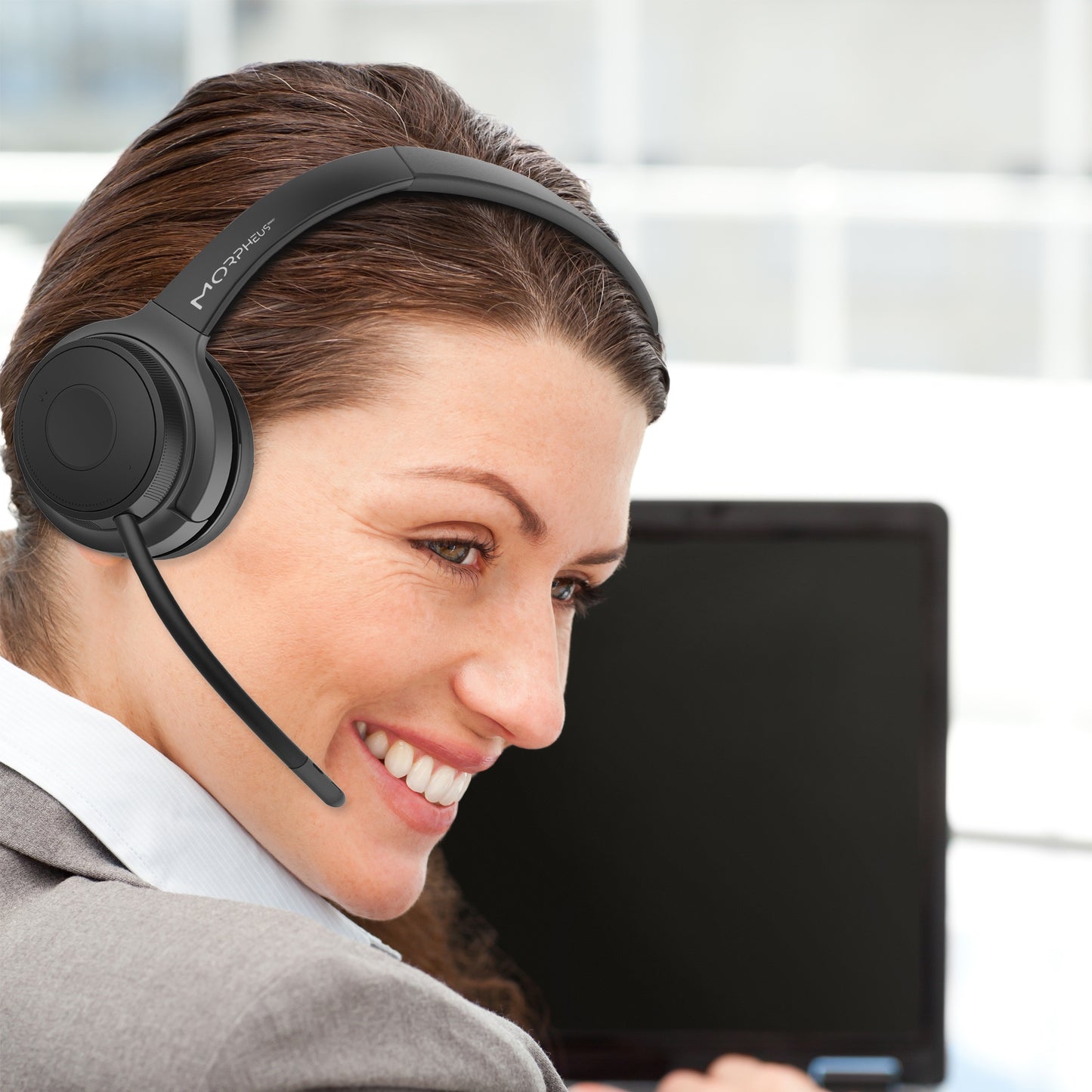 Businesswoman in an office wearing her Advantage Wireless Mono Headset with Boom Microphone and speaking to a customer.