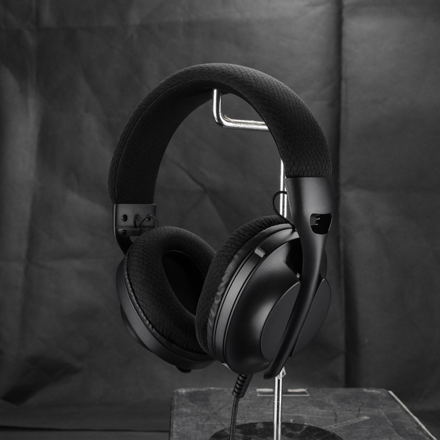 M360 Triple Connect Gaming Headset In Black with Microphone Down Tilted On Headset Stand