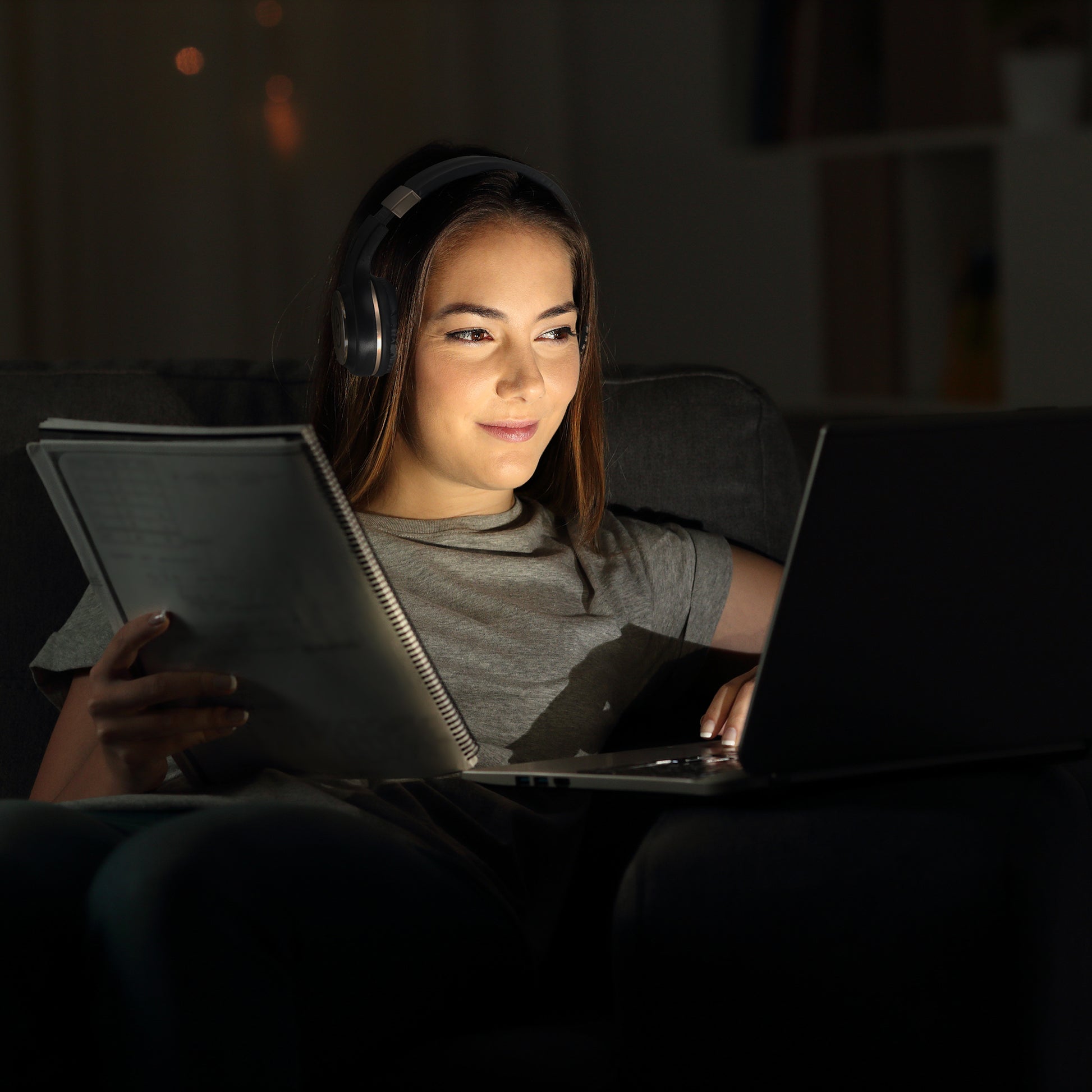 Photo of Morpheus 360 Serenity Wireless Over Ear Headphones with a young white female using them with her computer while working/school from home.