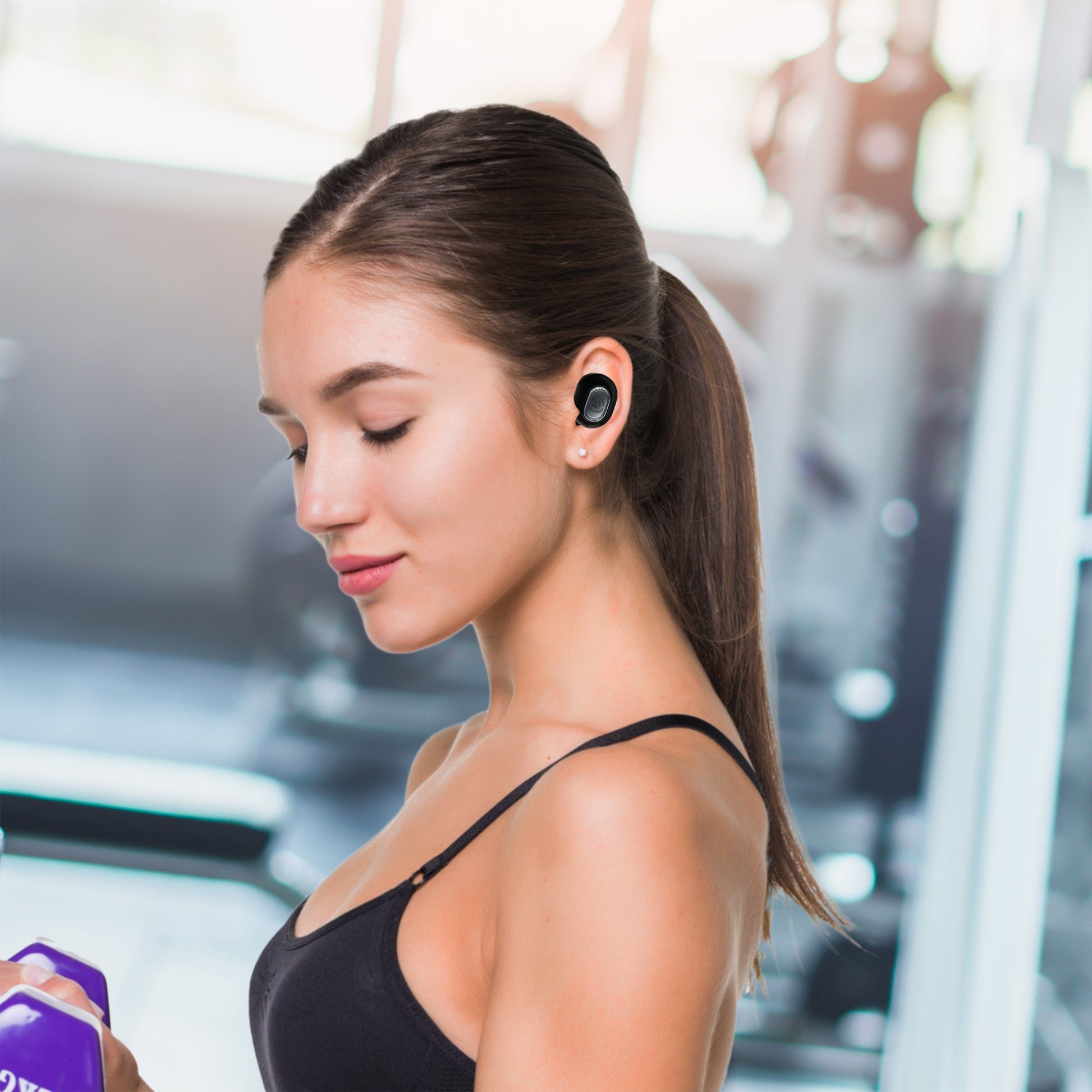Photo of Morpheus 360 Pulse 360 True Wireless Earbuds shows a young asian female using the Pulse 360 earbuds while working out.